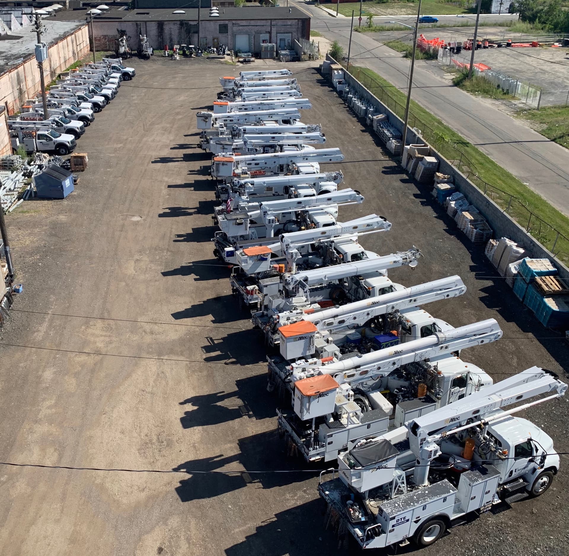 Aerial view of Universal Contracting's fleet of bucket trucks lined up in the Detroit yard